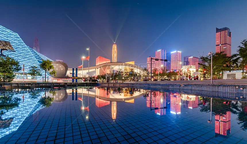 Illuminated high rise facades reflected in water at night