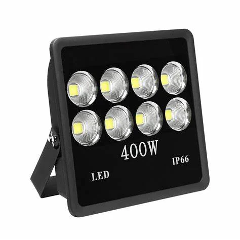 LED flood light luminaire with a sealed glass front and cooling fins