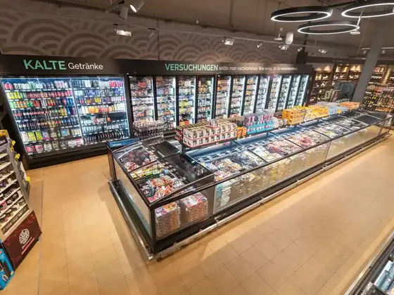 Chilled display counters in a food retail store lit with LED case lighting