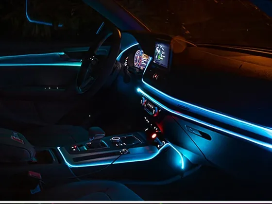 Car interior with blue ambient LED light lines along the dashboard and doors