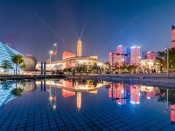 Illuminated high rise facades reflected in water at night