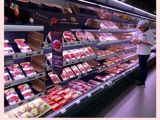 Open fronted chilled meat display case lit with LED cooler modules