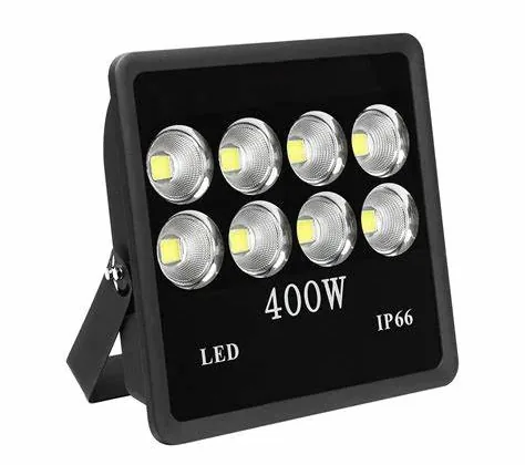 LED flood light luminaire with a sealed glass front and cooling fins