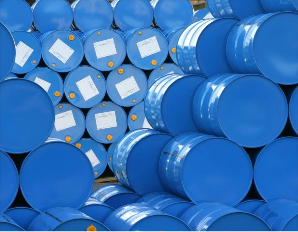 Blue steel drums of coating additives stacked in a warehouse