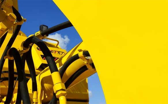 Yellow construction machinery finished in a titanium colour pigment coating