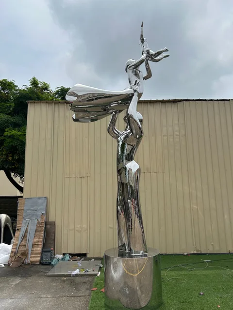 Large outdoor school hospital park square airport Stainless steel figure sculpture seen from another angle