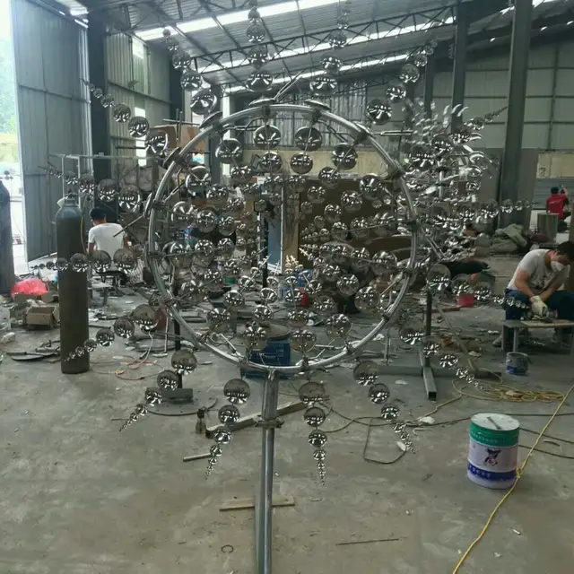 Outdoor Stainless Steel Rainbow Kinetic Wind Spinner Sculpture shown in its setting