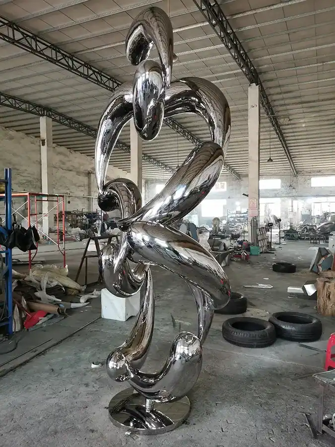 Large outdoor abstract stainless steel fish school sculpture