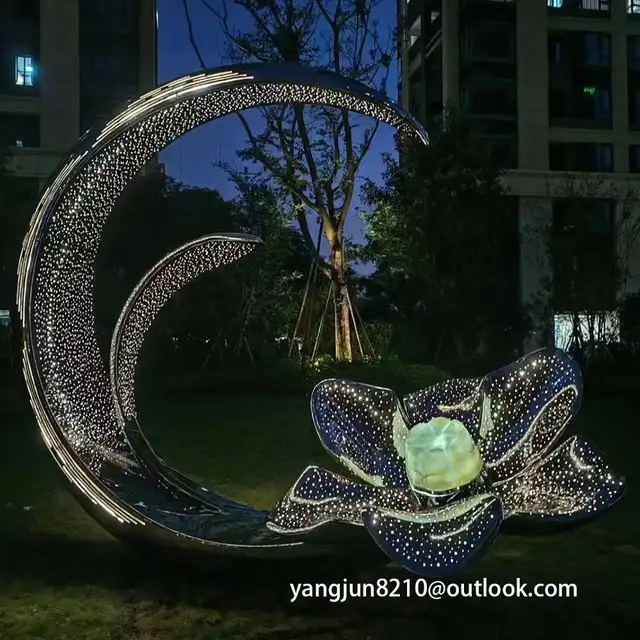 Large outdoor park square apartment playground theatre glowing stainless steel crescent sculpture seen from another angl