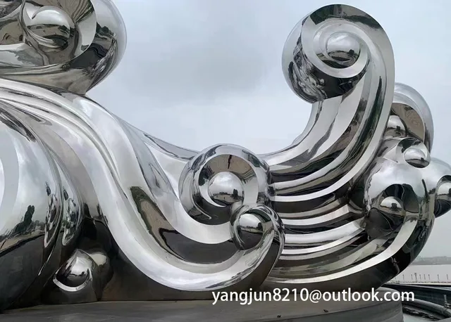 Large outdoor park square school courtyard subway polished stainless steel spray sculpture in close view