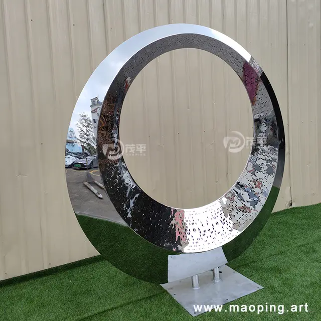 Large outdoor square beach luminous stainless steel ring sculpture in close view