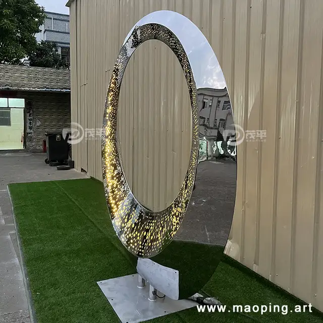 Large outdoor square beach luminous stainless steel ring sculpture from the side