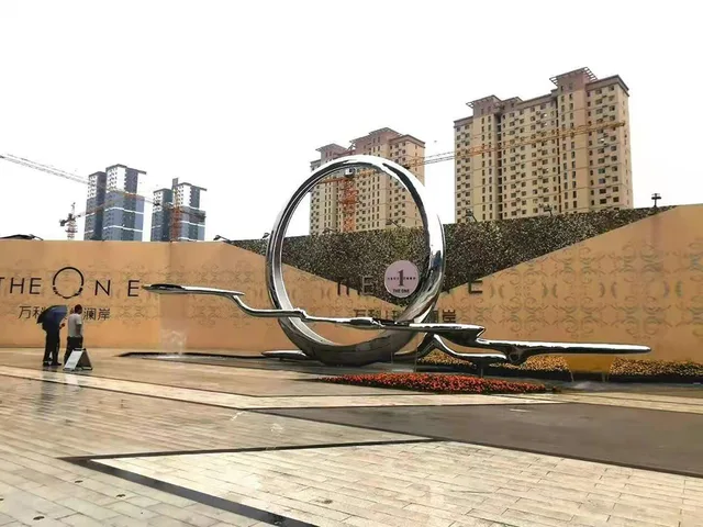 Large Outdoor square garden courtyard pool abstract stainless steel ring sculpture seen from another angle