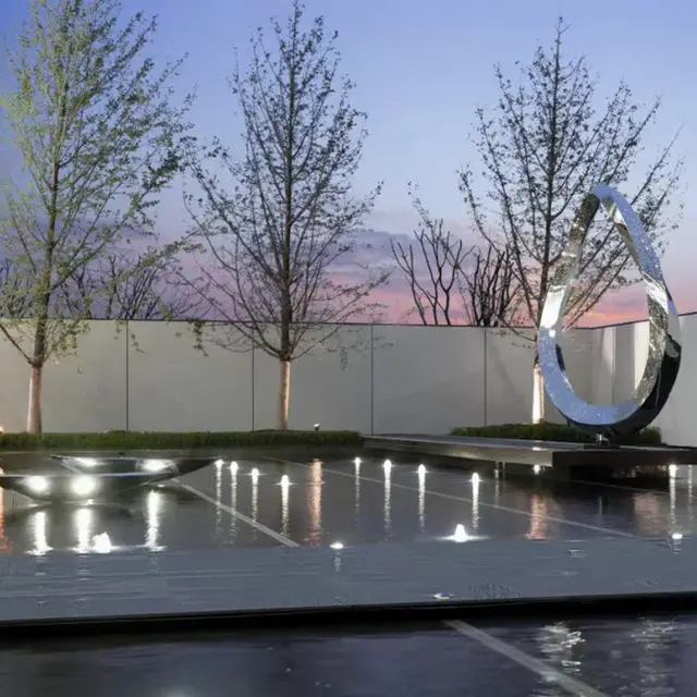 Large outdoor waterscape metal sculpture stainless steel ring sculpture seen from another angle