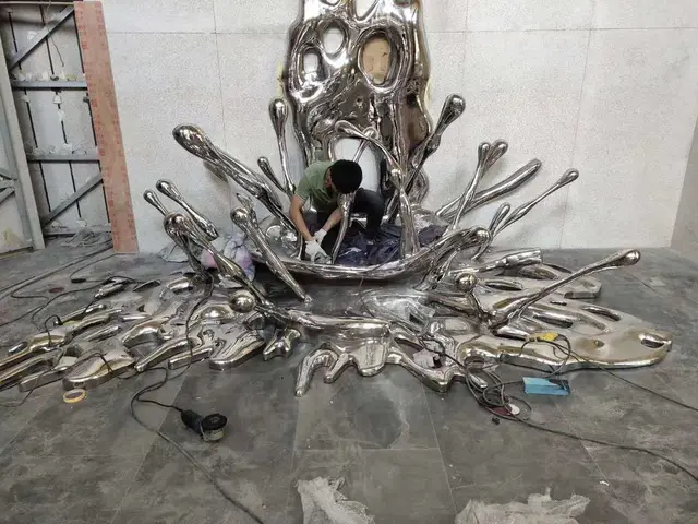 Large stainless steel spray sculpture seen from another angle