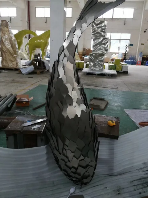 Large outdoor Luminous stainless steel fish sculpture seen from another angle