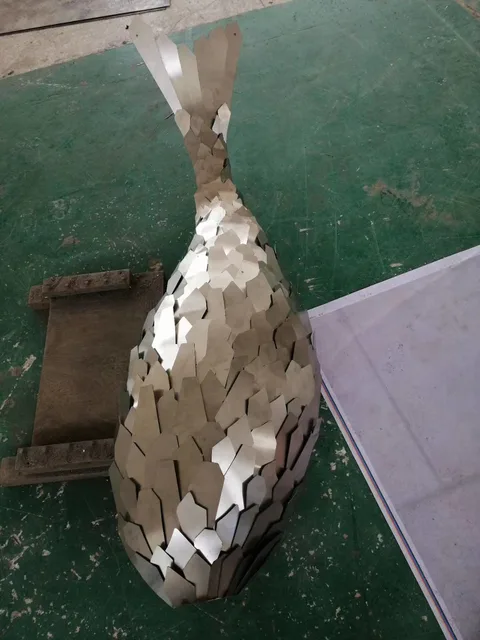 Large outdoor Luminous stainless steel fish sculpture in close view