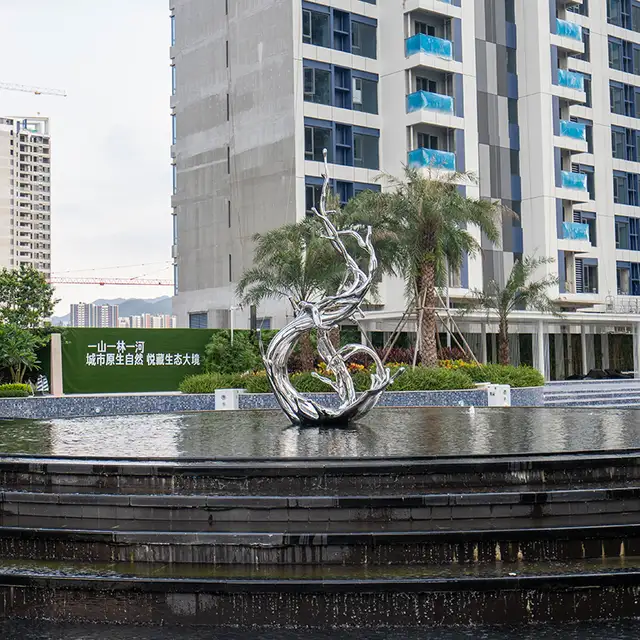 Modern large outdoor square pool stainless steel spray sculpture seen from another angle