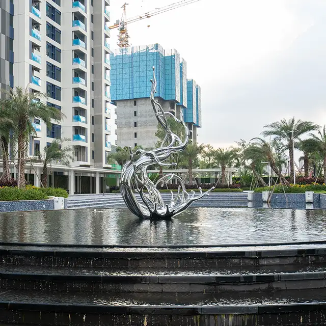 Modern large outdoor square pool stainless steel spray sculpture in close view