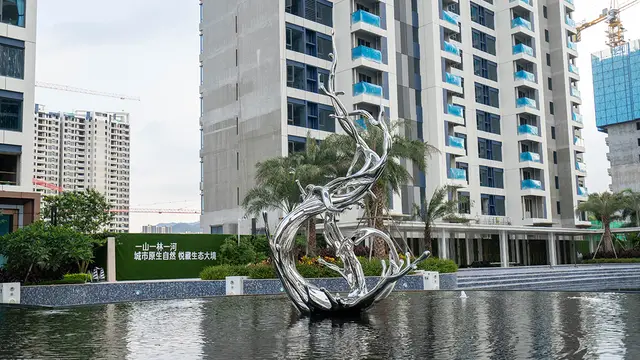 Large outdoor square beach metal art stainless steel abstract splash sculpture seen from another angle
