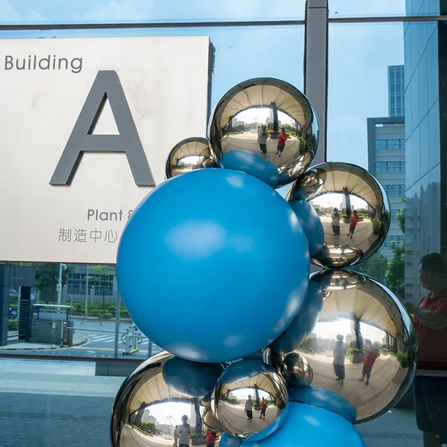 Modern outdoor abstract color stainless steel sphere sculpture in close view