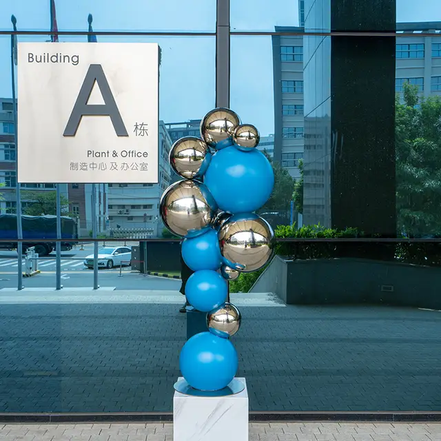 Modern outdoor abstract color stainless steel sphere sculpture seen from another angle