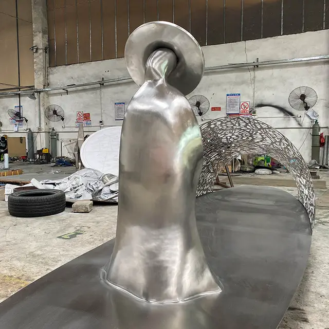 Modern outdoor park waterscape metal sculpture stainless steel boat sculpture seen from another angle