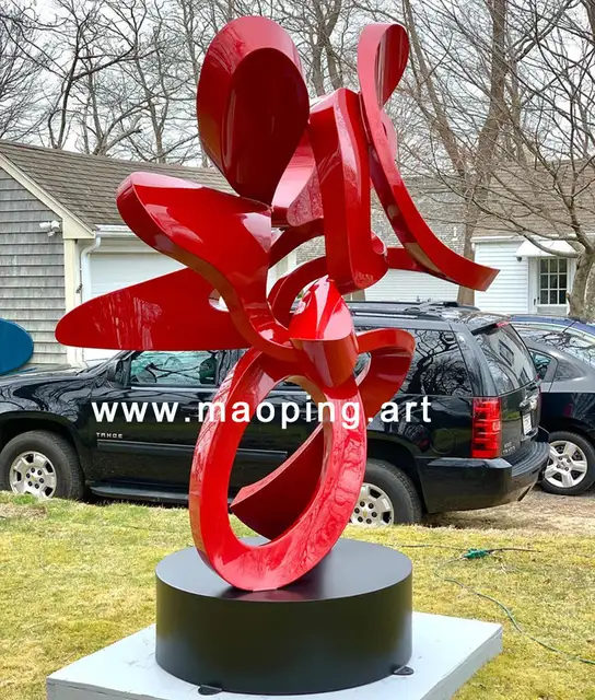 Outdoor garden courtyard Abstract red stainless steel sculpture in close view
