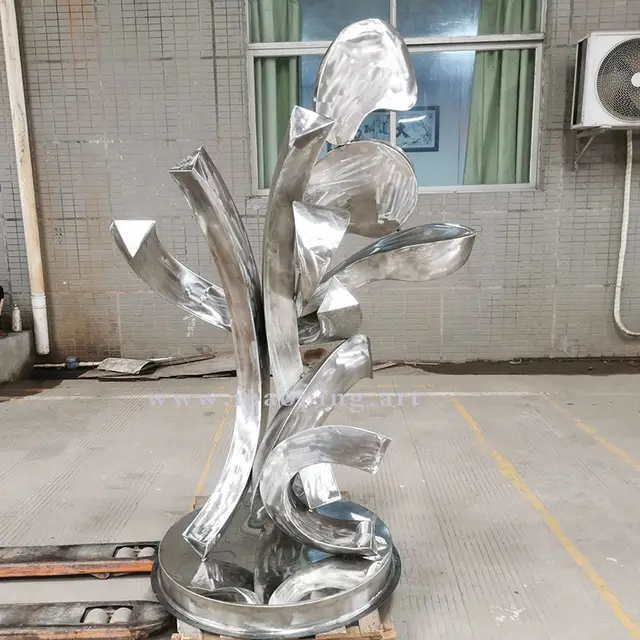 Outdoor garden courtyard yellow stainless steel abstract sculpture seen from another angle