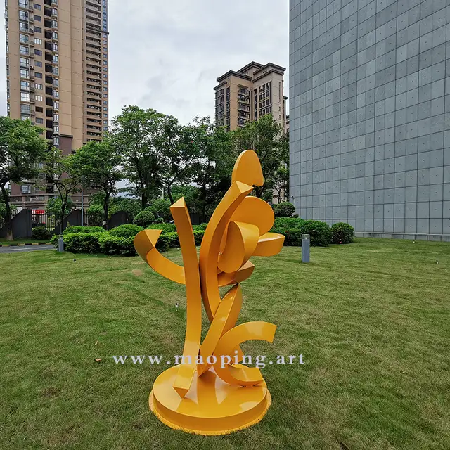 Outdoor garden courtyard yellow stainless steel abstract sculpture in close view