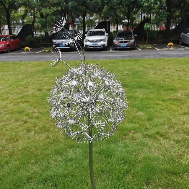 Outdoor garden grass Stainless steel dandelion sculpture in close view