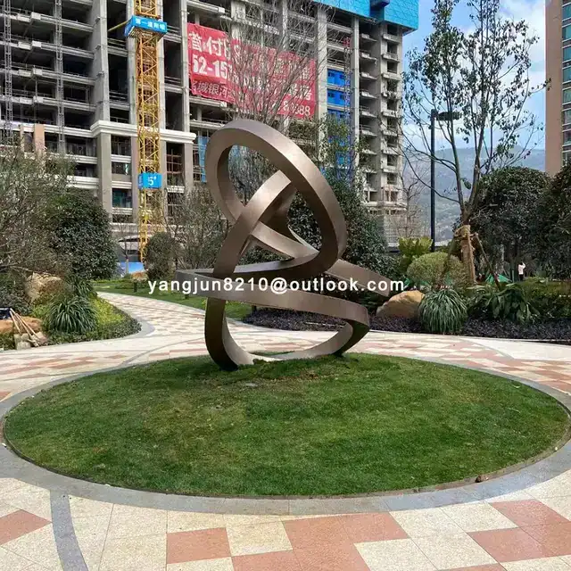 Outdoor square garden courtyard Abstract stainless steel Ring sculpture in close view