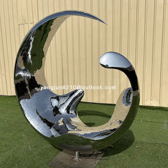 Outdoor square garden courtyard luminous stainless steel crescent sculpture seen from another angle