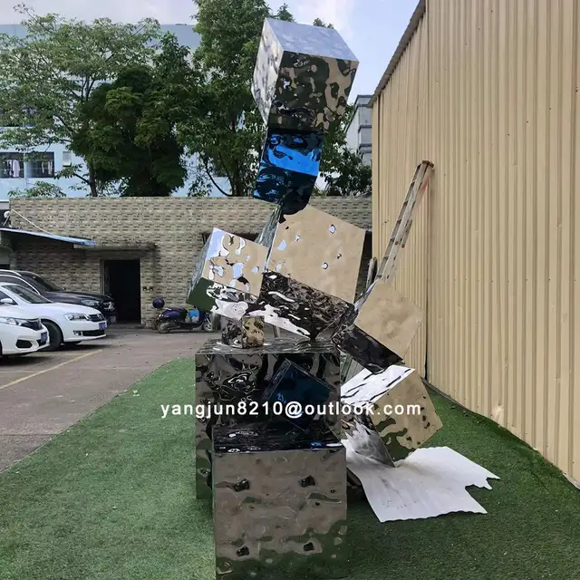 Outdoor square park beach green space stainless steel Cube sculpture in close view