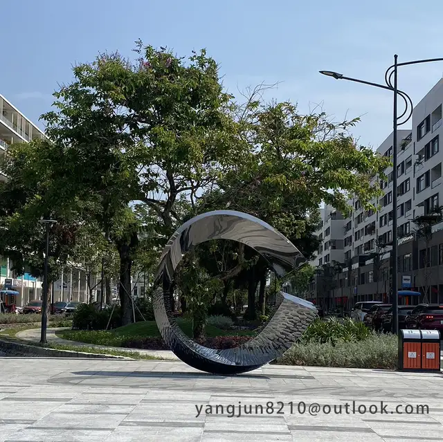 Outdoor square park library school airport theater art stainless steel “C”sculpture in close view