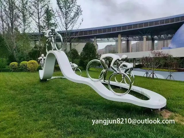 Outdoor square park playground museum architectural landscape artwork stainless steel bicycle sculpture seen from anothe