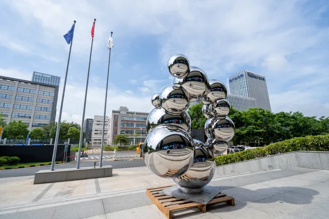 Outdoor stainless steel metal gold sphere sculpture seen from another angle