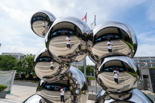 Outdoor stainless steel metal gold sphere sculpture from the side