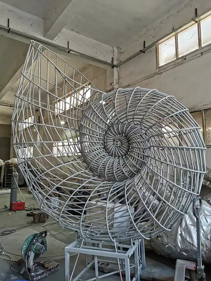 Large outdoor stainless steel conch sculpture