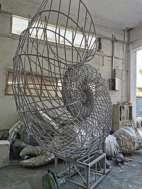 Large stainless steel spray sculpture in close view