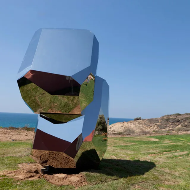 Modern abstract stainless steel polished stone snake seen from another angle