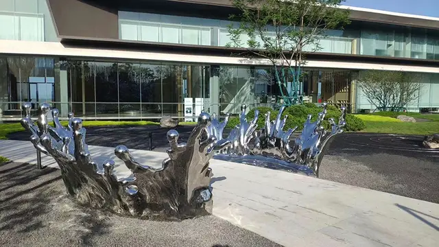 Large stainless steel spray sculpture from the side