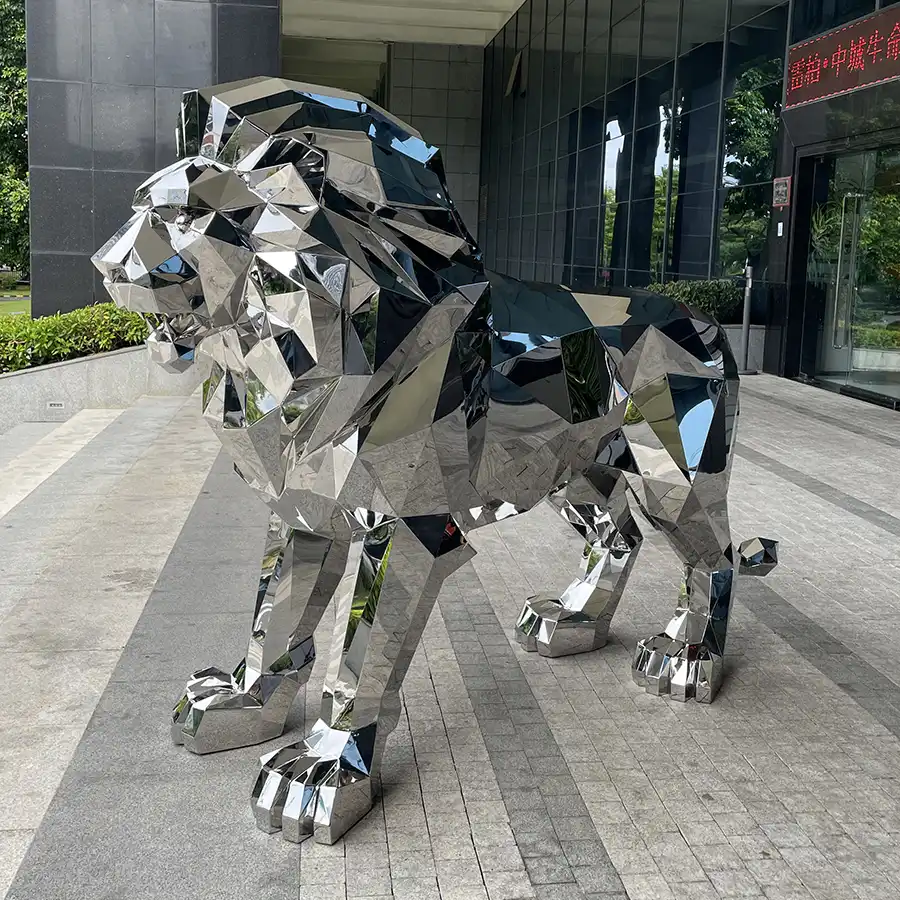 Geometric stainless steel lion installed at a commercial entrance