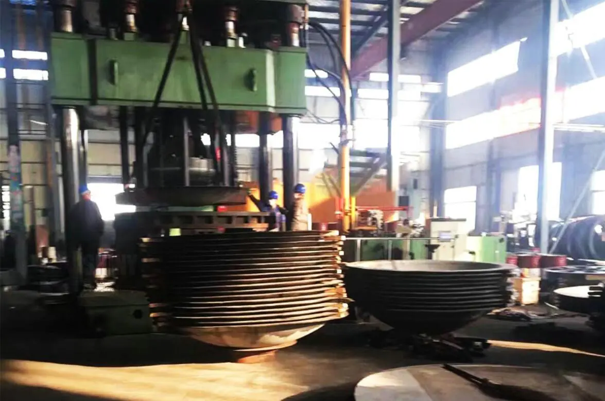 Large spun hemispheres stacked under the press on the heavy line