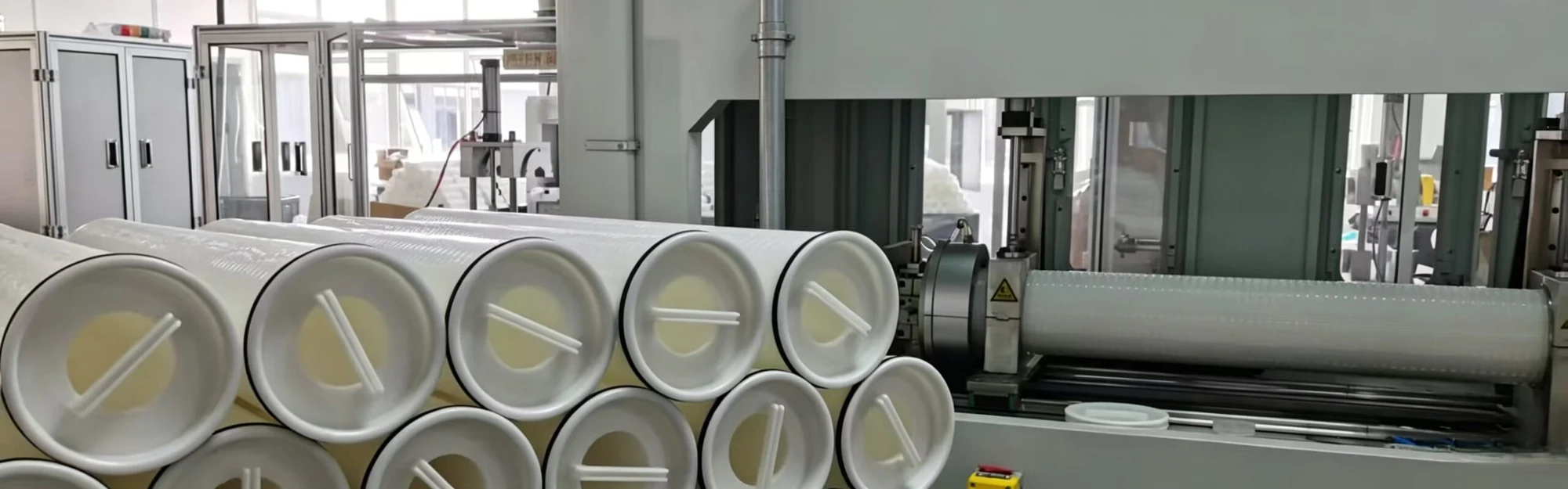 High flow filter cartridges stacked beside the pleating line in the Mykro Filter workshop