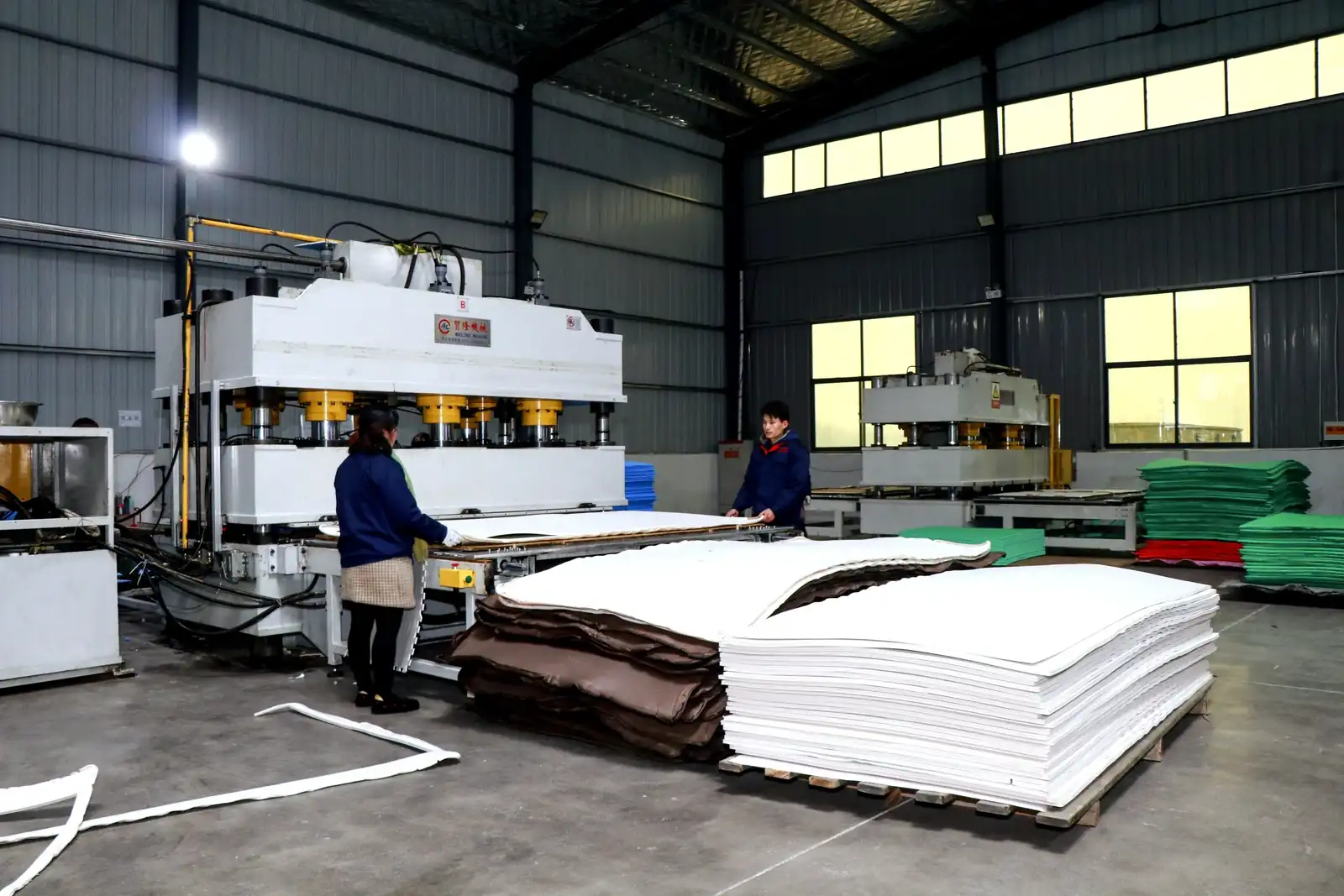 EVA foam sheets pressed to thickness on the production line