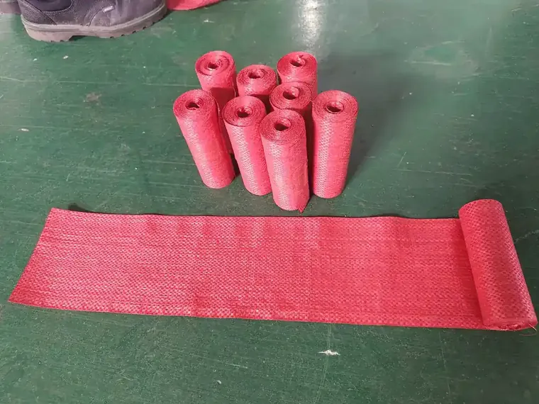 Slitting and rewinding machine running woven fabric during a tension mode check before crating.
