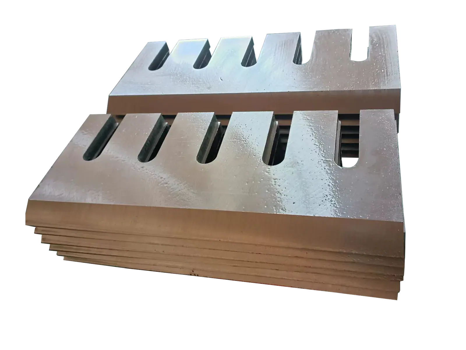 Stack of industrial slotted metal blades against a black background
