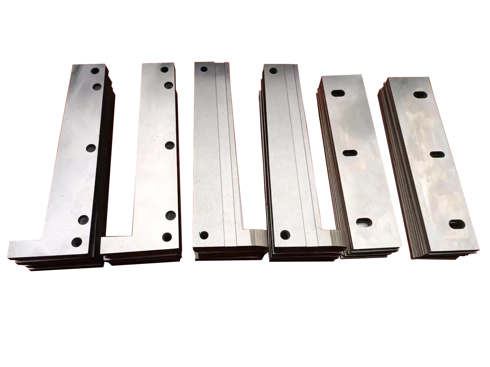 Stacks of metal industrial cutting blades against a dark background