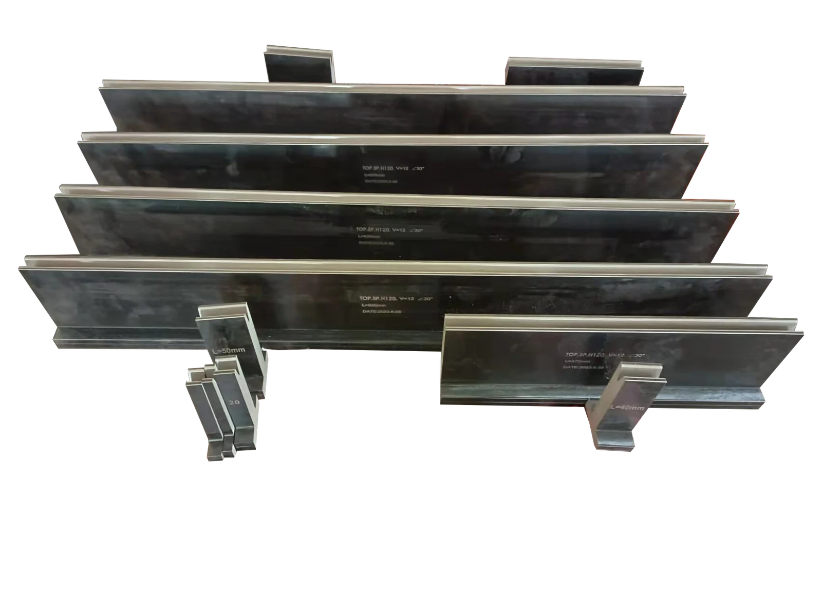 Industrial metal press brake tooling dies arranged against a black background